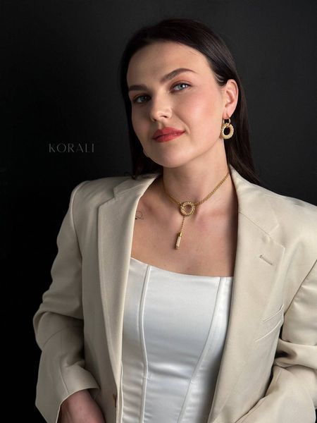 The "Horizon of Desire" pendant is beige and gold 511 photo