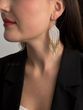 The earrings are white with gold sprinkles